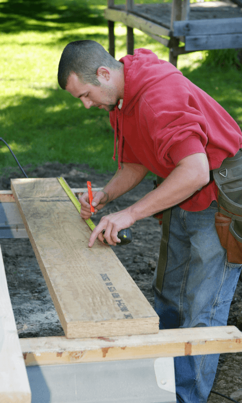 Man measuring boards