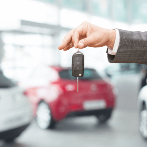 Automobile with someone holding car keys